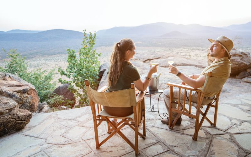 Romantic Safari- a couple on safari enjoying the incredible view from their verandah.