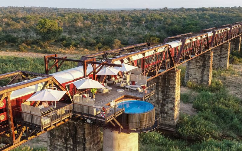 A luxury safari lodge built on a historic railway bridge in Kruger National Park, featuring private decks, a plunge pool, and breathtaking views of the African wilderness. A truly unique stay that makes a Kruger Safari worth it for travelers seeking exclusivity and adventure.