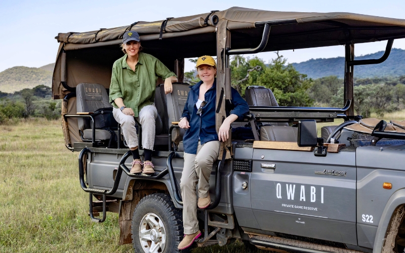 Vikki Jackson and Sian Loehrer seated on an open safari vehicle at Qwabi Private Game Reserve in South Africa’s Limpopo bushveld, preparing for a guided Big Five game drive.